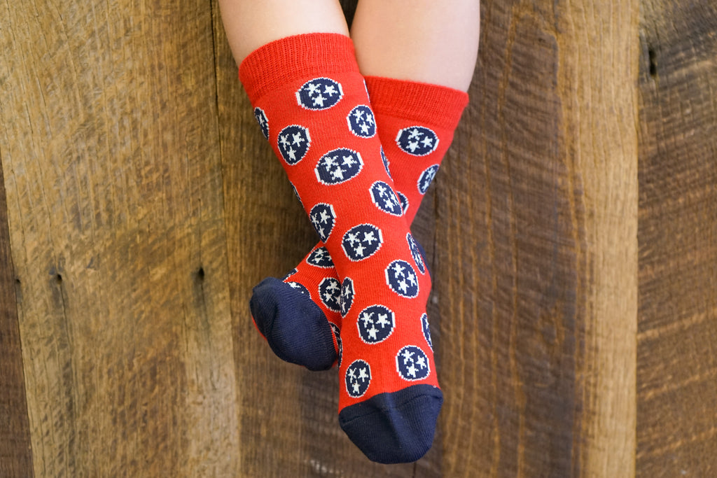 Volunteer Traditions Red and Navy Kid's Tristar Socks on Kids Feet.