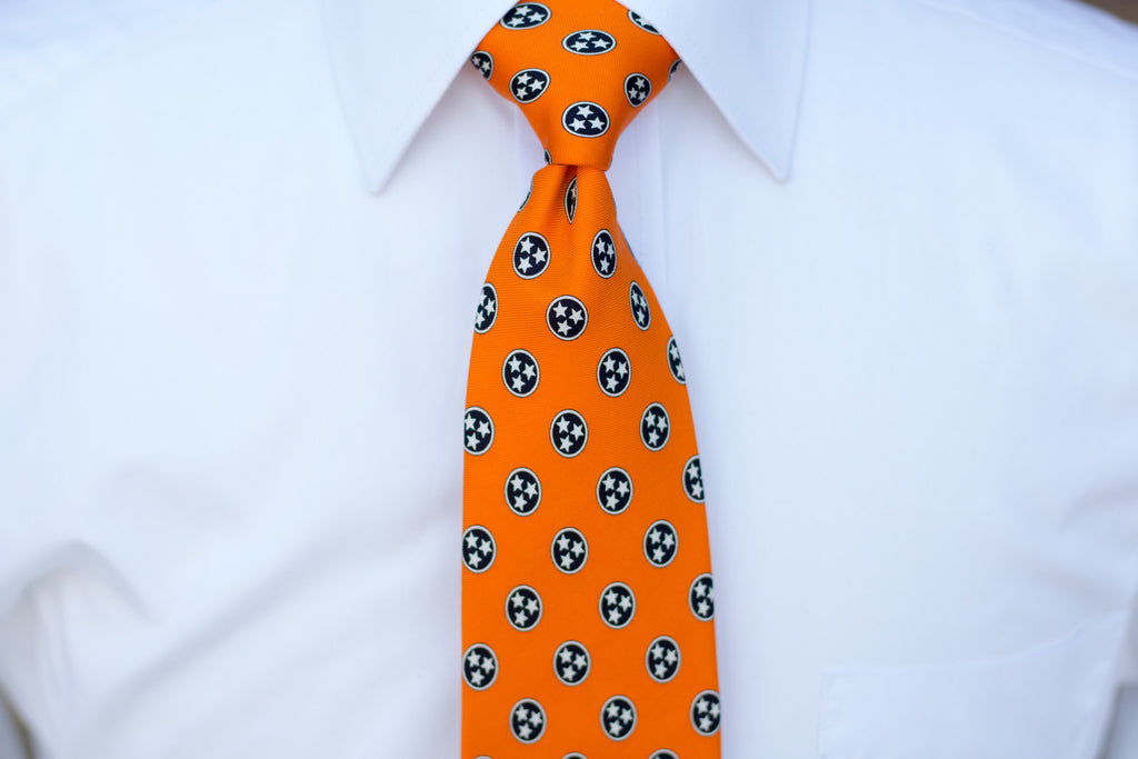 Volunteer Traditions Orange Tristar Tie on neck.