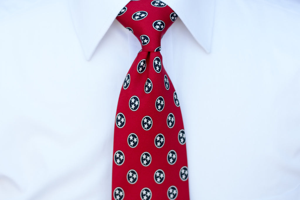 Volunteer Traditions Red Tristar Tie on neck.