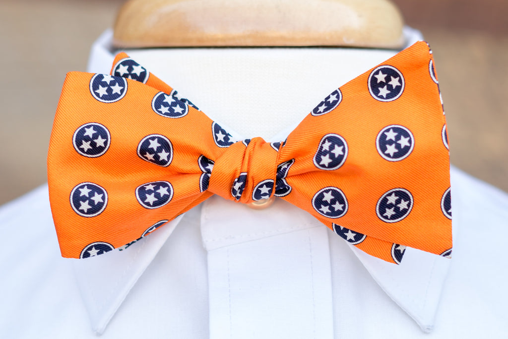 Volunteer Traditions Orange Bowtie featuring Navy Tristars on neck.