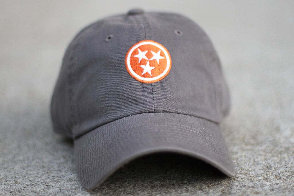 Grey with Orange Tristar Tennessee Hat Flag Volunteer Traditions on concrete.